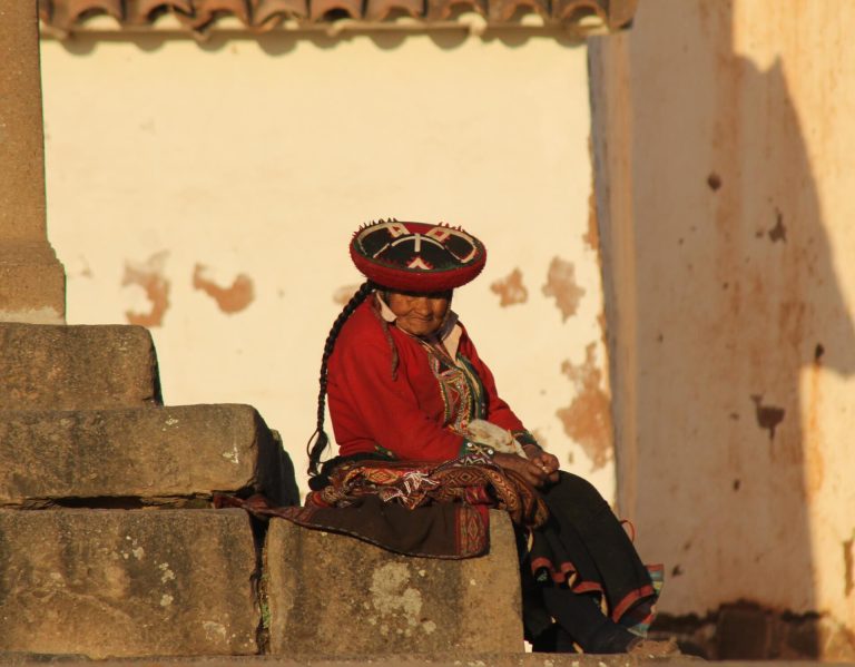 Woman in traditional Andean dress seated in Chinchero, Peru