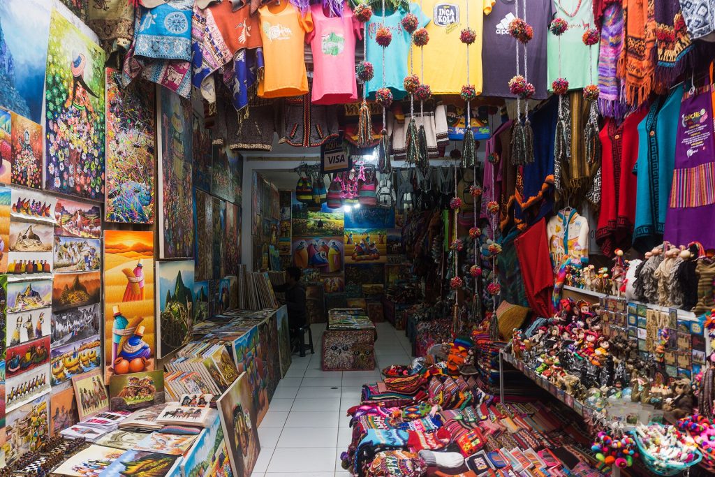 Colorful woven textiles displayed at Pisac market in Peru