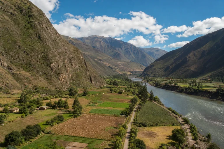 Wide view of the Sacred Valley in Peru with cultivated land and Andean mountains