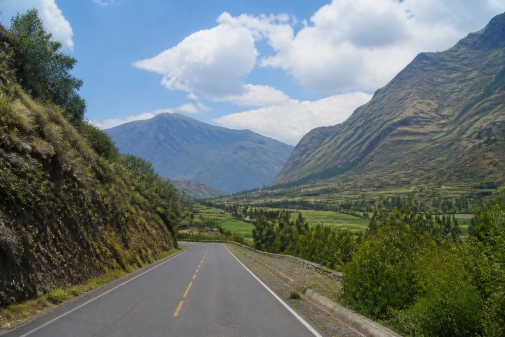 Paved road passing through agricultural scenery in Peru’s Sacred Valley.