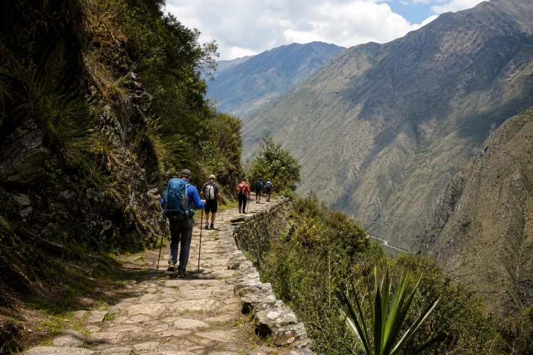 Hikers walking on an ancient stone path on Peru's Inca Trail