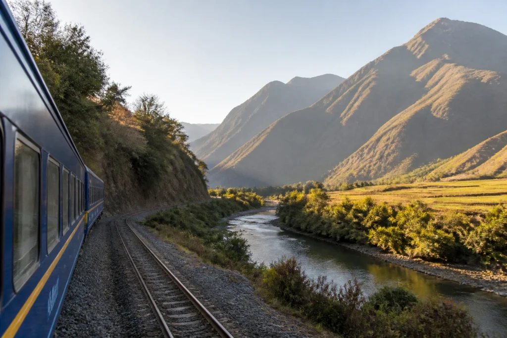 Passenger train traveling through the Sacred Valley near Ollantaytambo