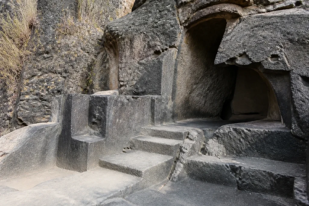 Carved basalt huaca within the volcanic rock at Ñaupa Iglesia