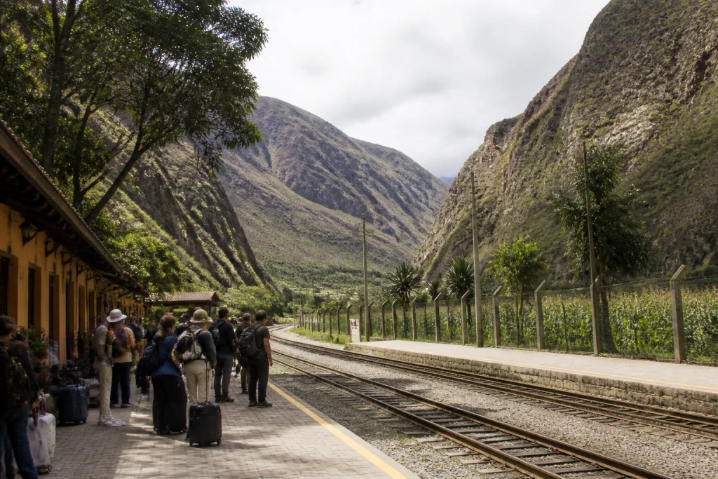 Railway tracks and travelers at Ollantaytambo station in the Sacred Valley