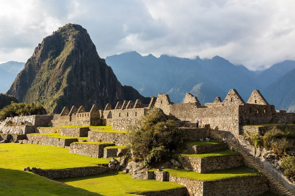 Authentic stone structures at Machu Picchu with surrounding mountains
