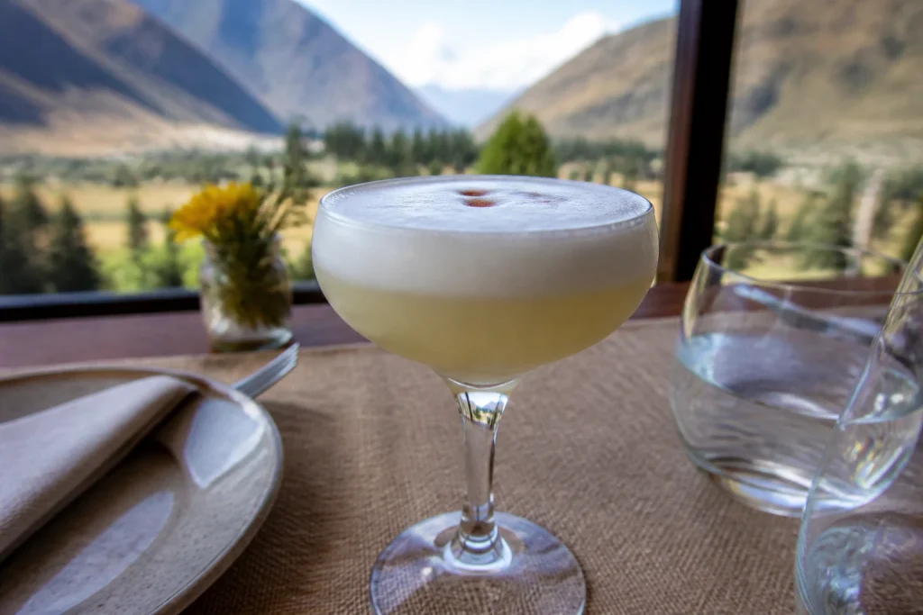 Close-up of a classic Pisco Sour with foam and bitters drops