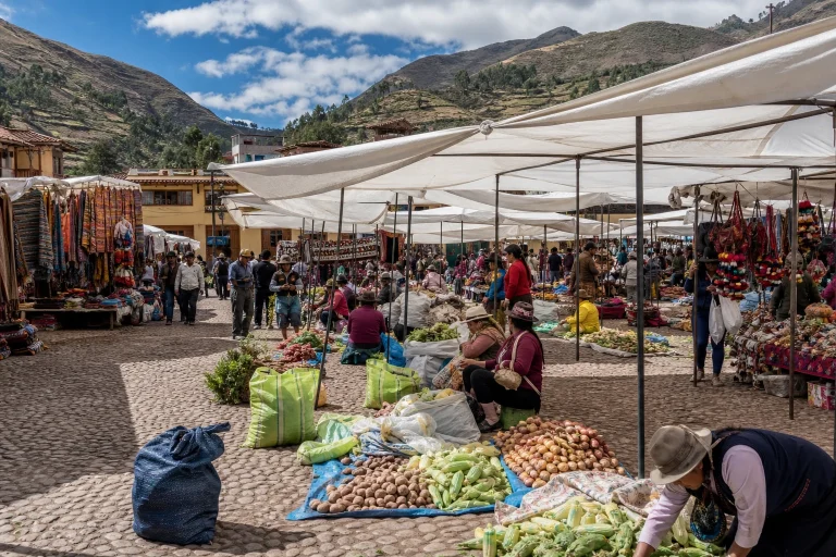 Market stalls with produce and artisan goods in Plaza Constitución at Pisac